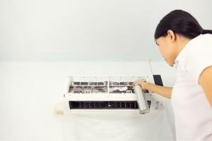 Woman Cleaning AC Evaporator Coil